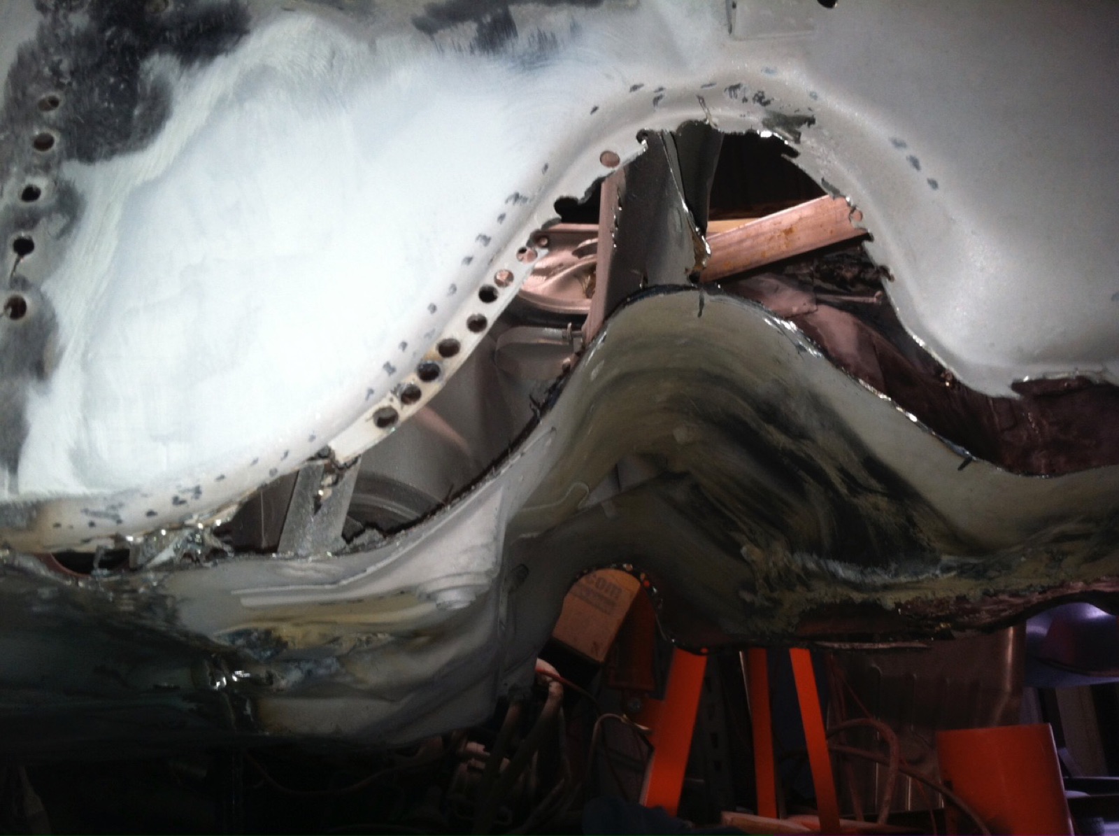 Rust holes revealed in the wheel arch after media blasting