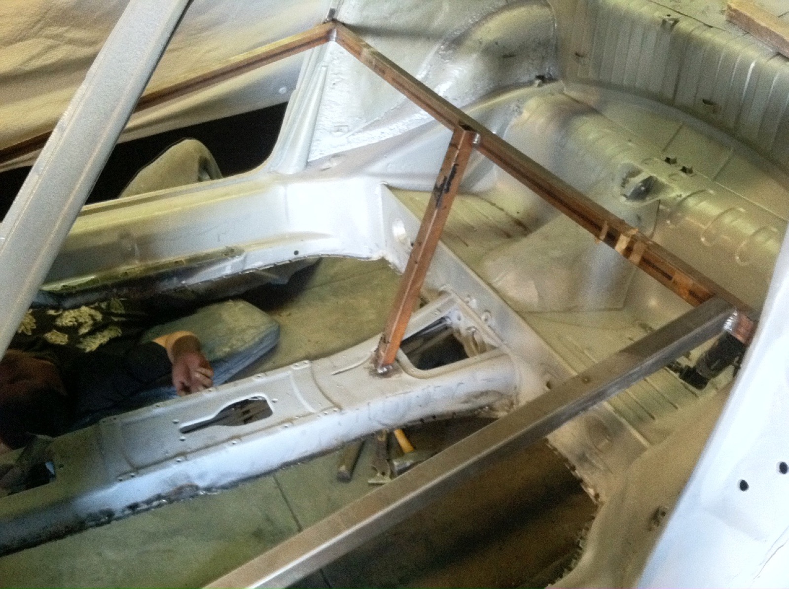 Stripped to bare metal — floor pans and bracing